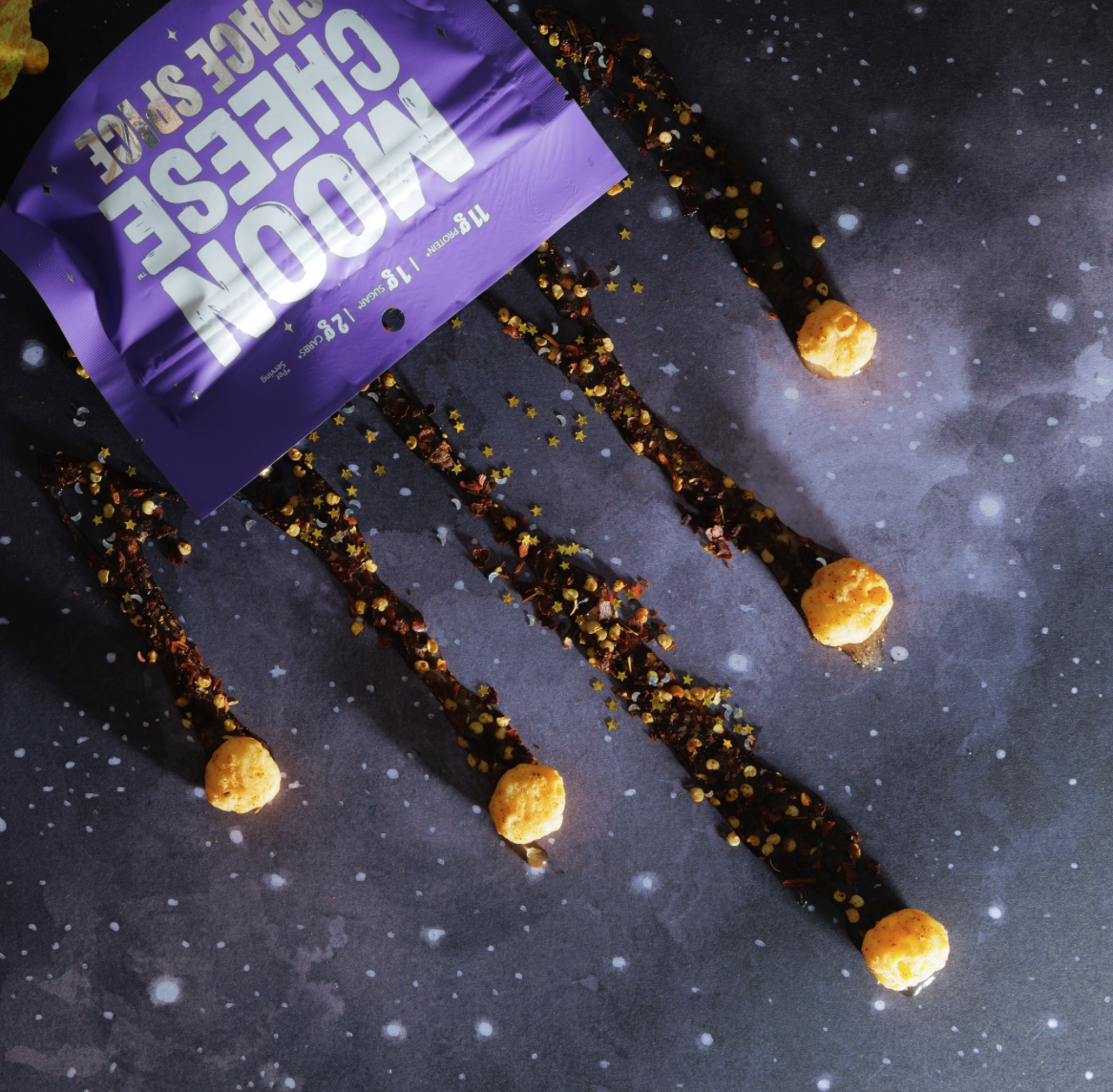 Moon Cheese Space Spice purple packaging with spice trails cascading down against starry background
